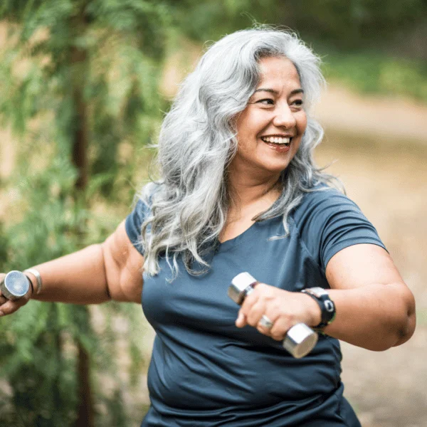 Happy woman lifting dumbbells