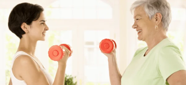 Happy women holding dumbbells for weight loss